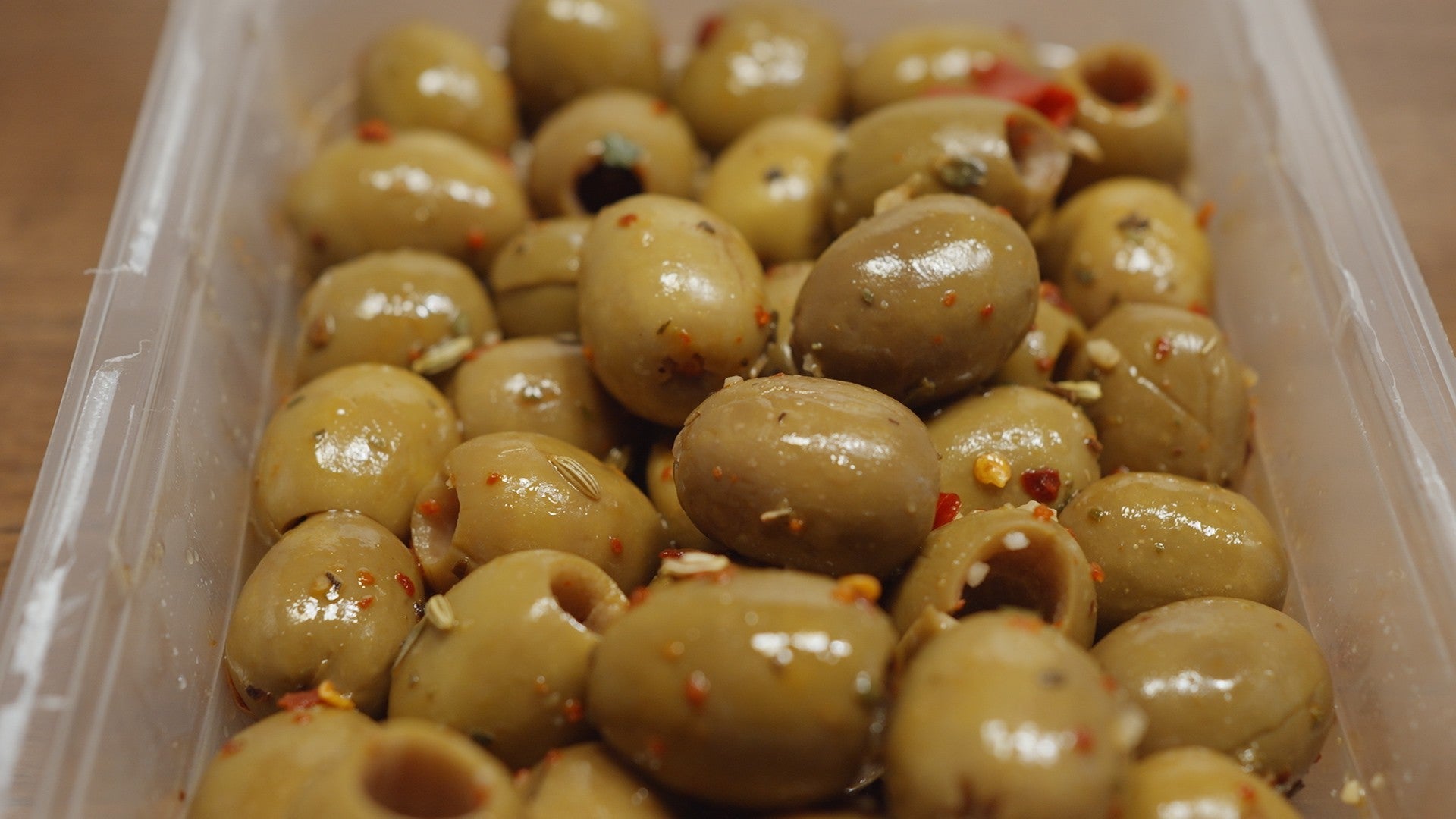 A close-up image of a 300g jar of handcrafted pitted green olives, labeled Olive Verdi Denocciolate Artigianali